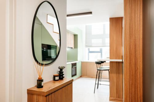 a mirror on top of a wooden dresser in a room at Matcha Studio in Bucharest
