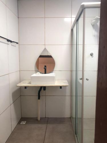 a bathroom with a sink and a shower at Oxx in Congonhas