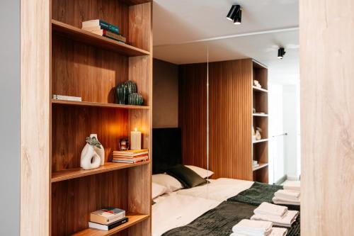 a bedroom with wooden shelves and a bed at Matcha Studio in Bucharest