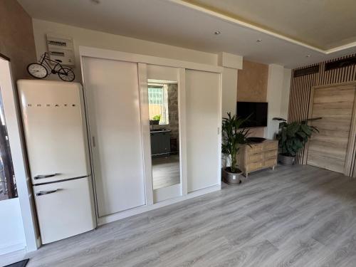 a room with a white refrigerator and a living room at Terrasse de Cimiez in Nice