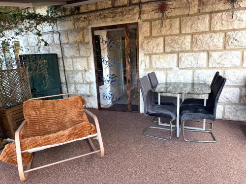 a table and chairs sitting next to a stone wall at Terrasse de Cimiez in Nice