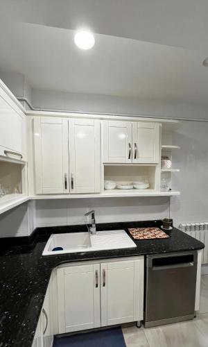 a kitchen with white cabinets and a sink at Spacious F3 in rouiba close to Algiers airport in Alger
