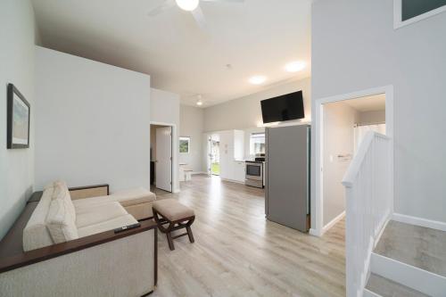 a white living room with a couch and a table at Ocean View Ranch in Hilo