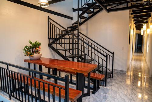 a stair case with a wooden table and benches at Strawberry House , Tour & Motorbikes Rentel in Ha Giang