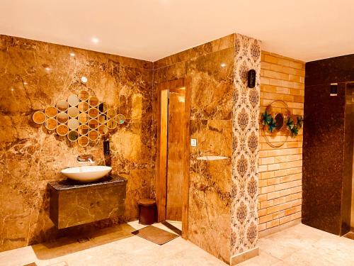 a bathroom with a sink and a shower at Hotel Classic Hills Bhagsunag Luxury Stay #Best Hotel in Mcleodganj #Mountain View Balcony Rooms #Spacious Parking #Prime Location in Dharamshala #Near Bhagsunag Waterfall #Top Selling Property in Mcleodganj in Dharmsala