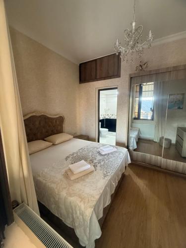 a bedroom with a bed and a chandelier at nino hotel in K'obulet'i