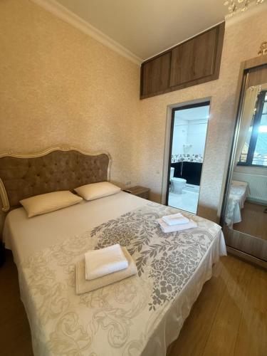 a bedroom with a bed with two towels on it at nino hotel in K'obulet'i