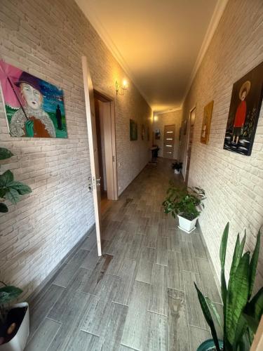 a hallway with plants and paintings on the walls at nino hotel in K'obulet'i