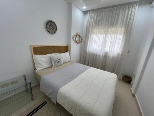 a bedroom with a large bed and a window at Mahdia front mer 3 in Hiboun