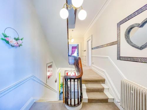 a staircase in a home with blue and white walls at -RBbc-Cozy Double Room in Shared House in Moortown