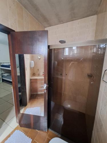 a bathroom with a shower with a toilet in it at Hostel Feel Home in Blumenau