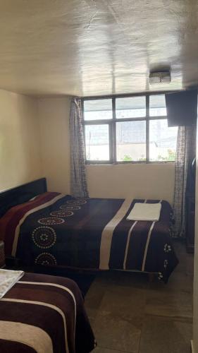 Ένα ή περισσότερα κρεβάτια σε δωμάτιο στο Hotel Zaragoza