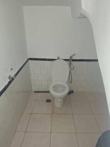 a bathroom with a white toilet in a stall at Jennas place in Tangier
