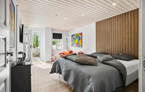 a bedroom with a large bed with a wooden ceiling at 1 Bedroom Beautiful Apartment In Bogense in Bogense