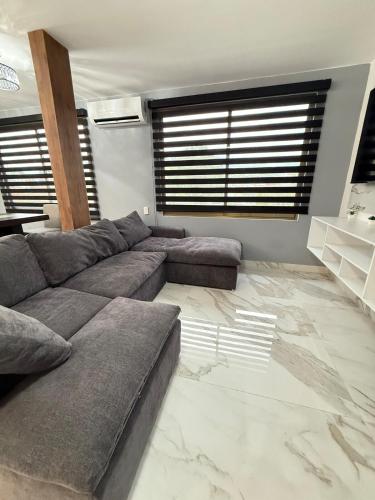 a living room with a couch and a marble floor at Incredible Luxury apartment in TGZ Chis in Tuxtla Gutiérrez