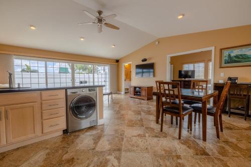 a kitchen with a table and a washing machine at Tropical Retreat GuestHouse in Hilo