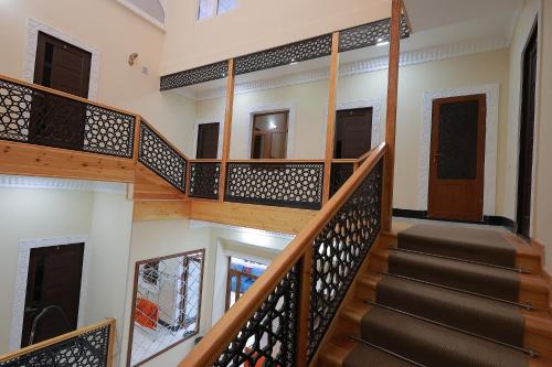 a staircase in a house with wooden railings at People Tours Bukhara in Muruntau