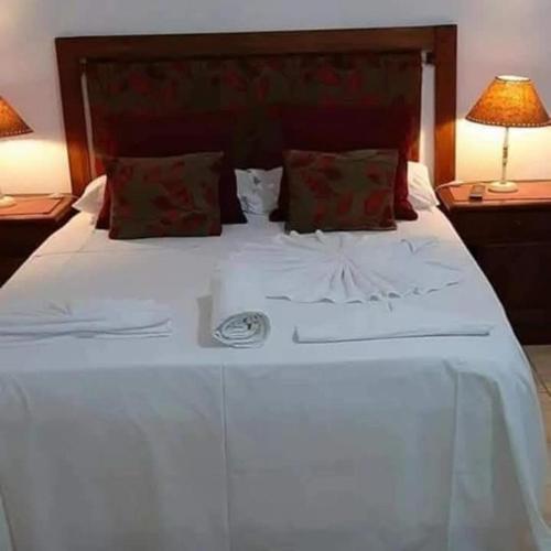 a large white bed with two pillows on it at Complejo Alma Misionera in Puerto Iguazú