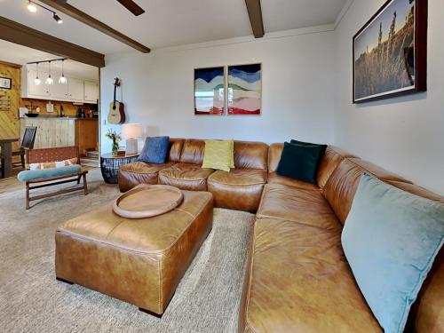 a living room with a brown leather couch at 1849 Condos 542 condo in Mammoth Lakes