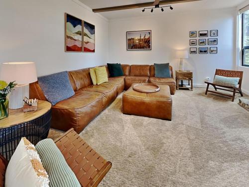 a living room with a brown leather couch at 1849 Condos 542 condo in Mammoth Lakes