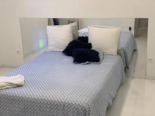 a bed with white pillows and a blue comforter at Subterranean Delight #DHG in Brétigny-sur-Orge