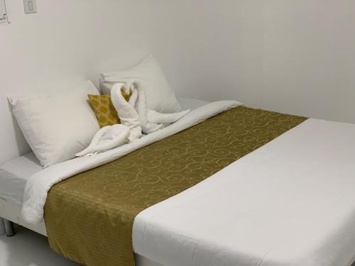 a bed with white sheets and towels on it at Subterranean Delight #DHG in Brétigny-sur-Orge