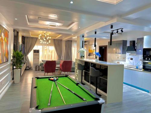 a living room with a pool table in a kitchen at Kirbys Cove in Lekki