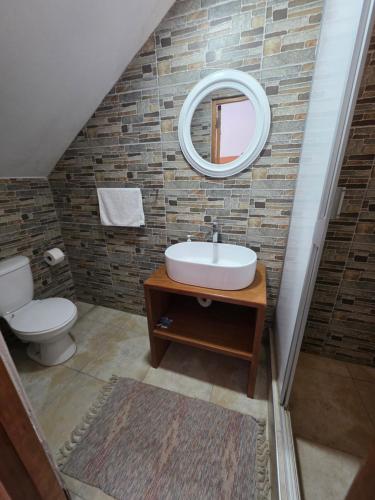 a bathroom with a sink and a mirror at Posada Casa Bonita in Puerto Maldonado