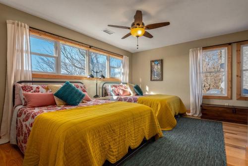 a bedroom with two beds and a ceiling fan at Ozark Retreat with Mountain Views Fire Pit & Deck in Parthenon