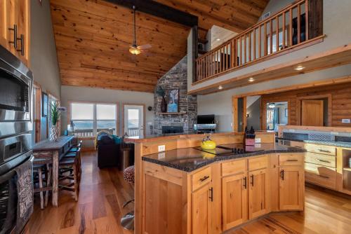 a kitchen with wooden cabinets and a dining room at Ozark Retreat with Mountain Views Fire Pit & Deck in Parthenon