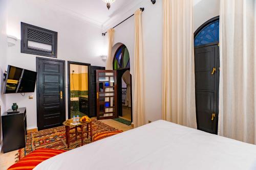 a bedroom with a bed and a view of a room at Riad Dar Dialkoum in Marrakech