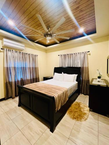 a bedroom with a bed and a ceiling fan at Kingston Oasis One Bedroom in Kingston