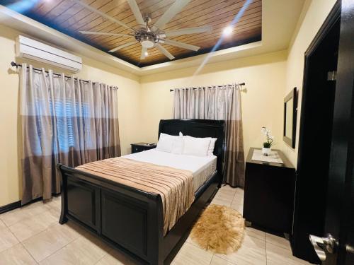 a bedroom with a bed and a ceiling fan at Kingston Oasis One Bedroom in Kingston