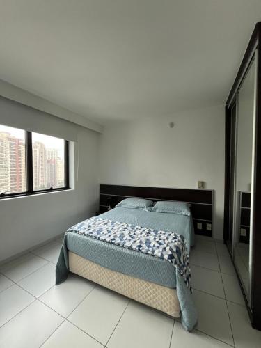 a white bedroom with a bed and two windows at Hotel Moema Shopping Ibirapuera Com Garagem 1420 in Sao Paulo