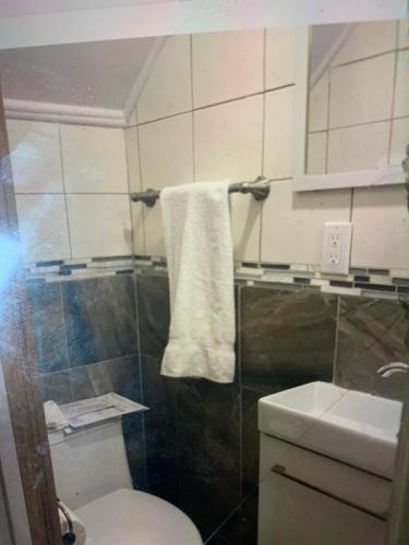 a bathroom with a white toilet and a sink at Room downtown 3minute walk Uottawa train station in Ottawa