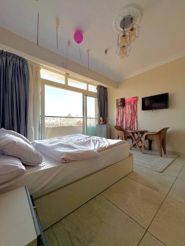 a bedroom with a large bed and a window at Giza pyramids view & jacuzii in Cairo