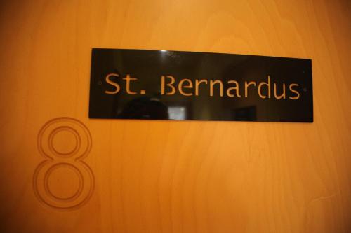 a sign that says st benarius on a wall at Hotel Salvators in Bruges