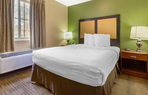 a hotel room with a large bed and a window at Extended Stay America Suites - Raleigh - North Raleigh - Wake Towne Dr in Raleigh