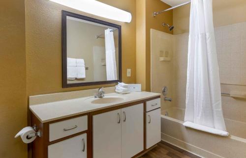 a bathroom with a sink and a shower with a mirror at Extended Stay America Suites - Raleigh - North Raleigh - Wake Towne Dr in Raleigh