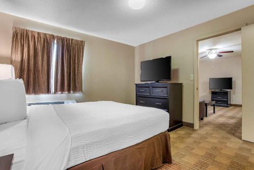 a hotel room with a bed and a flat screen tv at Extended Stay America Suites - Houston - Willowbrook - HWY 249 in Houston