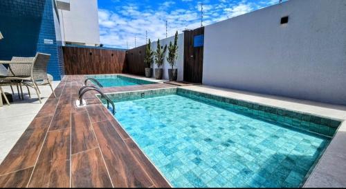 a swimming pool on the side of a building at Smart Residence Praia in Maceió