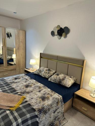 a bedroom with a large bed and a mirror at residence nid d'abeille in Bejaïa