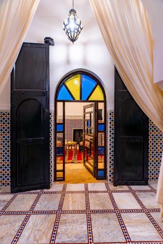 a room with two doors and a mirror at Riad Dar Dialkoum in Marrakech