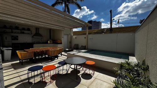 a patio with a table and chairs next to a swimming pool at New apartment in Bethaville, comfortable, Barueri in Barueri