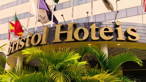 a hotel sign in front of a building at GRU Airport Hotel - STAY HERE in Guarulhos