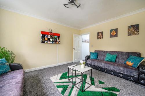 a living room with a couch and a table at H17A Cosy & Welcoming home in Liversedge