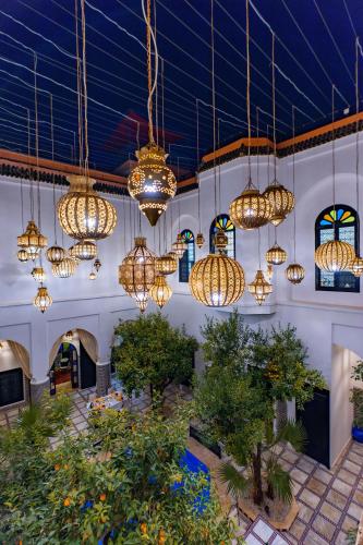 a room with many chandeliers hanging from the ceiling at Riad Dar Dialkoum in Marrakech
