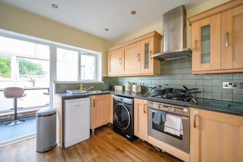 a kitchen with a stove and a dishwasher at H17A Cosy & Welcoming home in Liversedge