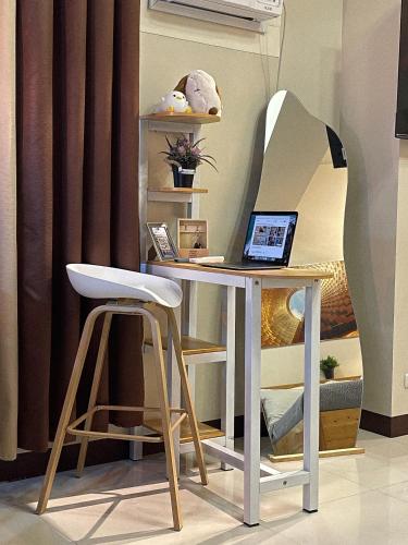 a desk with a chair and a laptop on it at NAIA Terminal 3 Condo Newport with WIFI Netflix Pool in Manila