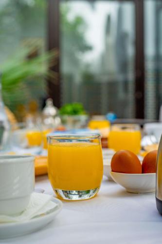 a table with a glass of orange juice and eggs at Riad Dar Dialkoum in Marrakech